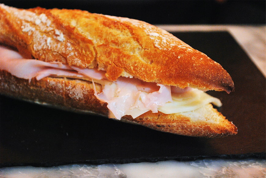 Close-up of toasted baguette sandwich with ham and cheese