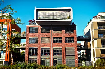 Modern brick building with white rooftop extension