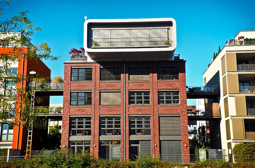 Modern brick building with white rooftop extension