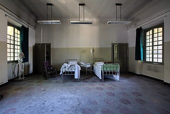 Abandoned Hospital Ward Interior With Old Beds And Skeleton