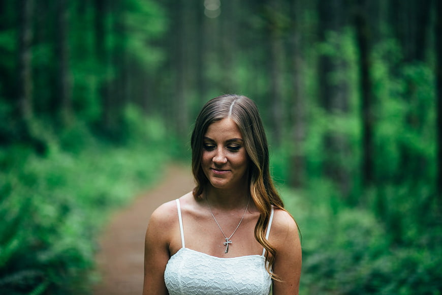 Serene Woman in White Lace Top Walking on Forest Path
