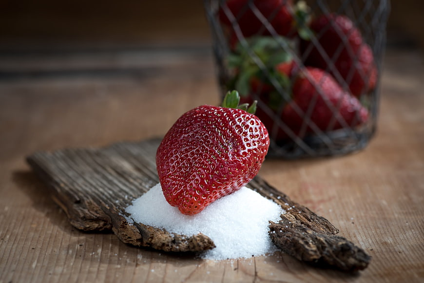 Fresh Strawberry on Sugar with Rustic Wood Background