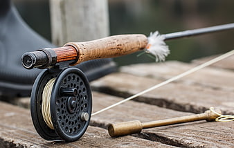 Vintage Fly Fishing Rod And Reel On Weathered Wooden Dock