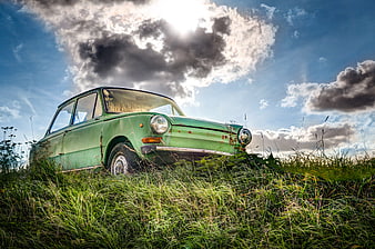 Vintage Green Car Abandoned in Grassy Field