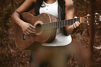 Woman Playing Acoustic Guitar in Forest