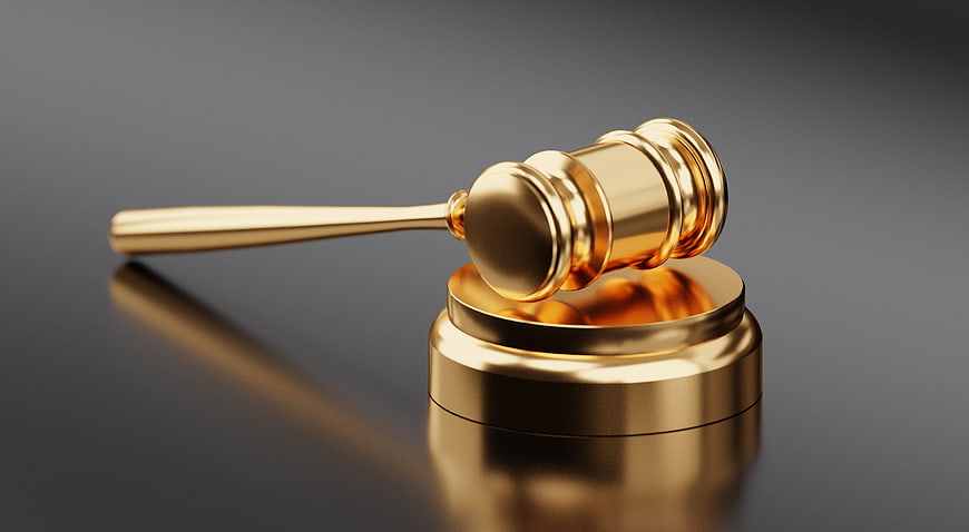Golden Gavel And Sound Block On Dark Reflective Surface