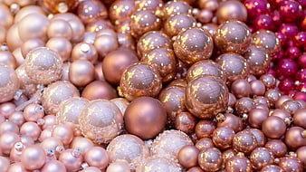 Close-up of shiny gold and rose gold Christmas ornaments