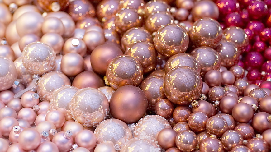 Close-up of shiny gold and rose gold Christmas ornaments