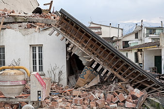 Collapsed house with rubble and debris after earthquake