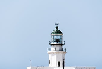 White Lighthouse Tower Top Against Clear Blue Sky
