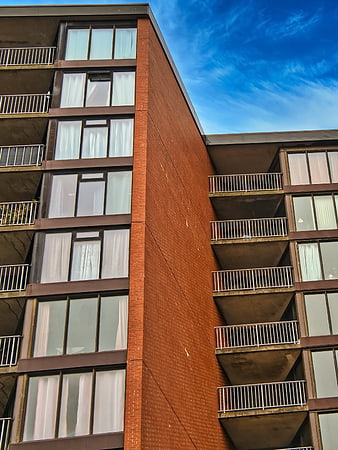 Modern Brick Apartment Building Exterior with Blue Sky