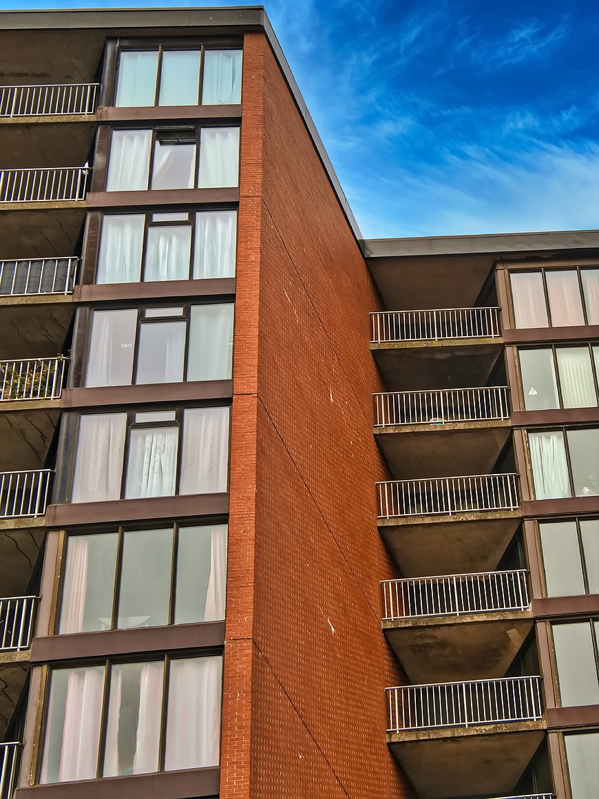 Modern Brick Apartment Building Exterior with Blue Sky