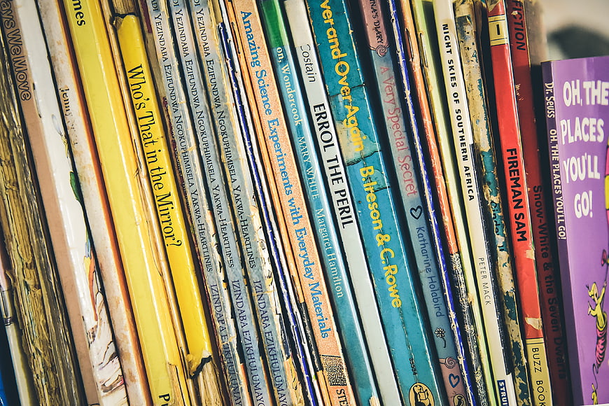 Close-up of vintage book spines on a shelf