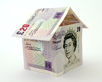 House made of British twenty pound banknotes on white background