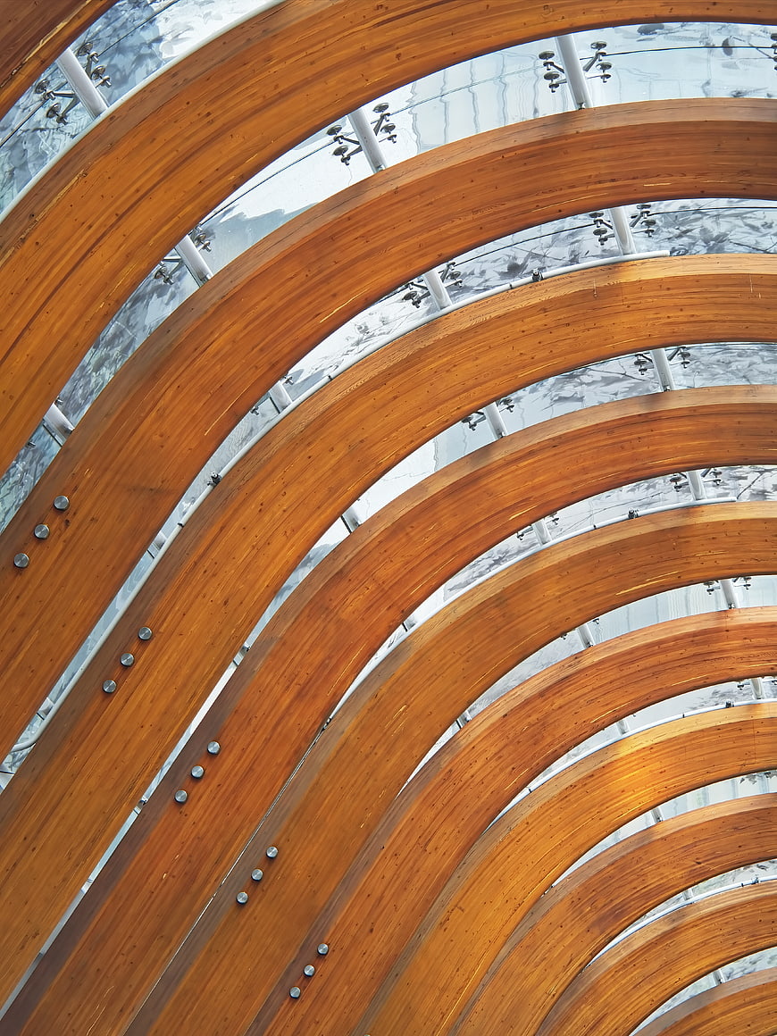 Curved wooden beams in modern architectural ceiling structure