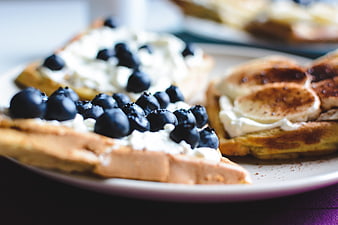Close-up of waffles with blueberries and cream