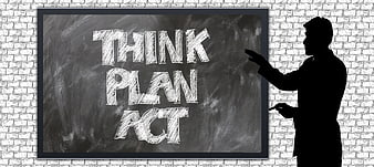 Silhouette of man pointing at chalkboard with think plan act text
