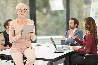Senior Businesswoman with Tablet in Office Meeting