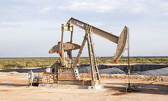Industrial Oil Pump Jack In Desert Landscape
