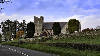 Historic stone church in rural Ireland with autumn trees