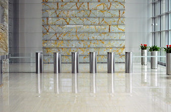 Modern corporate lobby with marble wall and stainless steel bollards