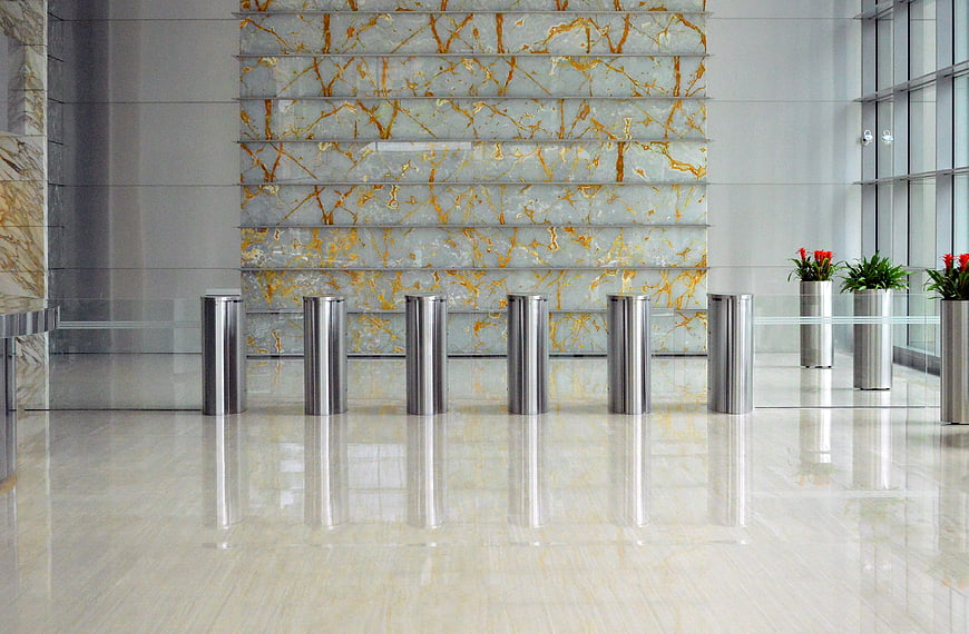 Modern corporate lobby with marble wall and stainless steel bollards