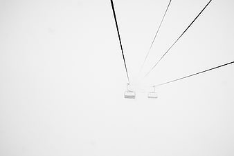 Minimalist Ski Lift Chairs in Heavy Fog