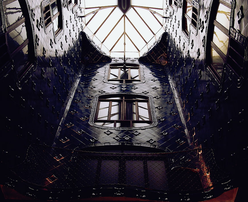 Dark Gothic Interior with Studded Walls and Skylight