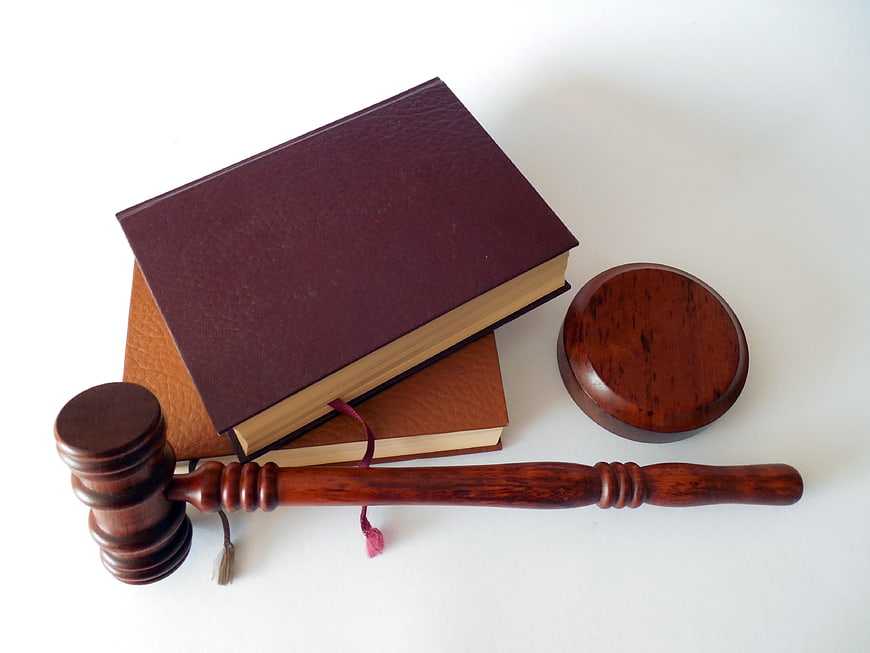 Wooden Gavel and Law Books on White Background