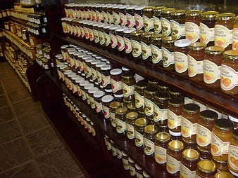 Shelves of homemade fruit jams and marmalades in a rustic country store