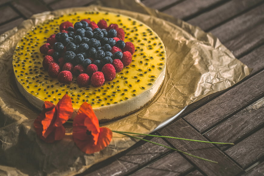 Passion Fruit Cheesecake with Berries and Poppy Flowers