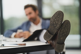 Man with feet up on desk in office
