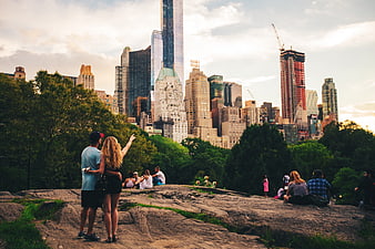 Couple Pointing at New York City Skyline from Central Park