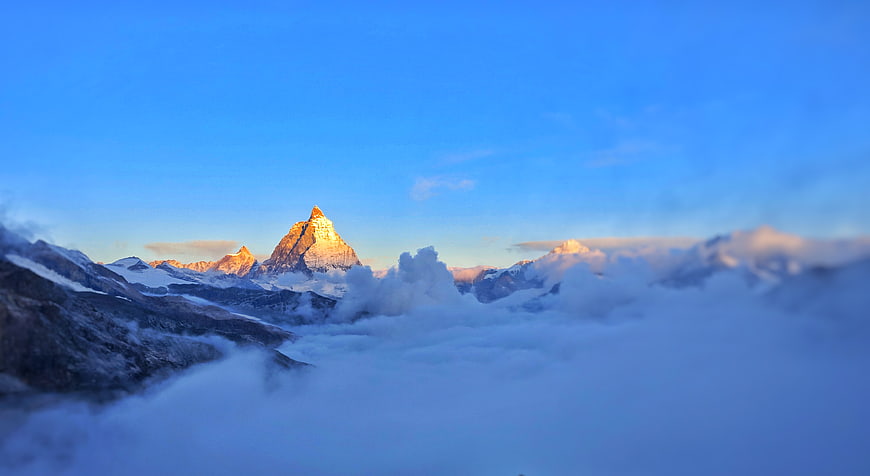 Matterhorn mountain peak above clouds at sunrise