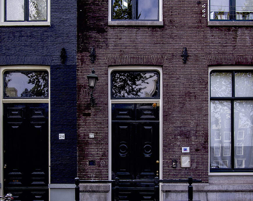 Traditional Dutch Canal Houses with Brick Facades and Doors