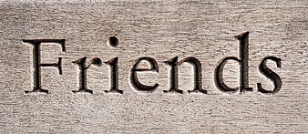 Word Friends Carved into Weathered Wood Texture