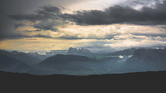 Dramatic Mountain Landscape with Cloudy Sky and Sunbeams