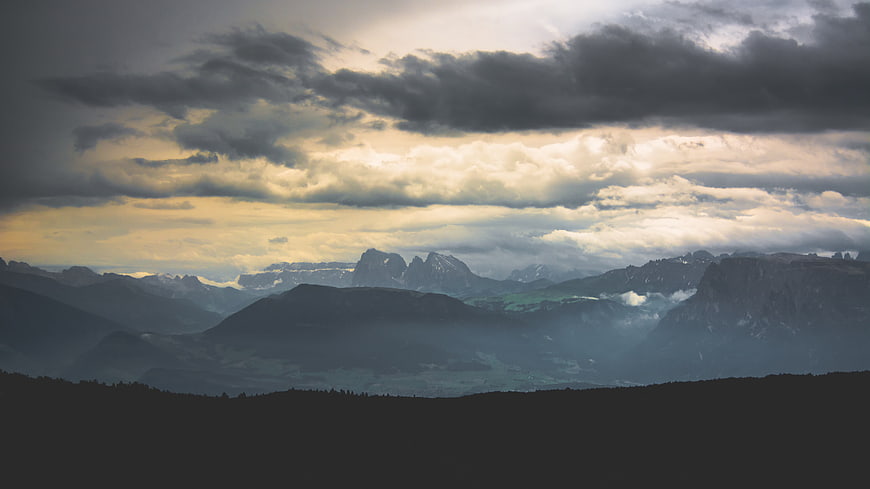Dramatic Mountain Landscape with Cloudy Sky and Sunbeams