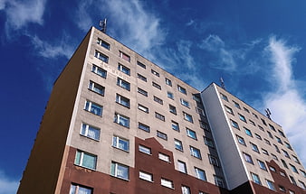 Low angle view of modern apartment building against blue sky