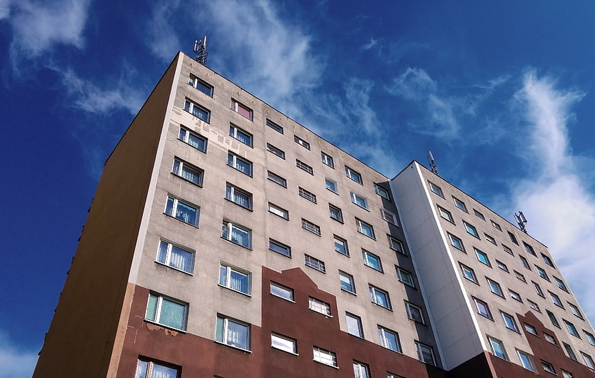 Low angle view of modern apartment building against blue sky