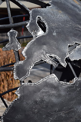 Close-up of black metal globe sculpture with Europe map