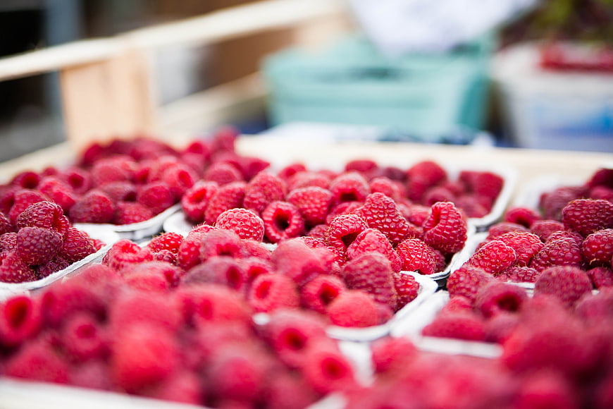 Fresh Raspberries in Plastic Containers at Market