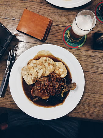Overhead view of Czech roasted duck with dumplings and beer