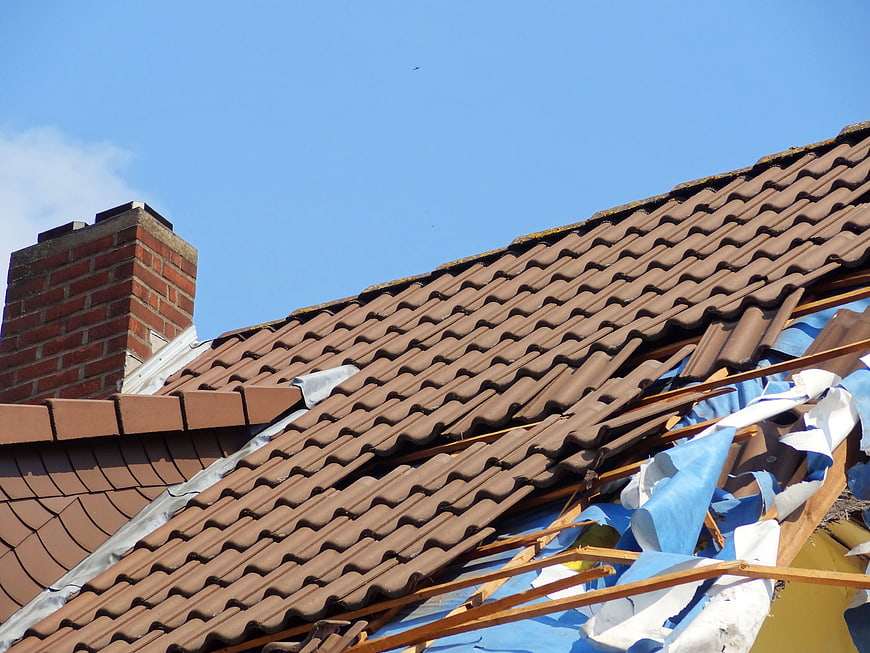 Damaged Roof Tiles and Exposed Structure After Storm