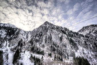 Snowy Mountain Landscape with Cable Car and Cloudy Sky