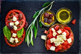 Mediterranean Tomato Bruschetta and Olives on Dark Slate Board