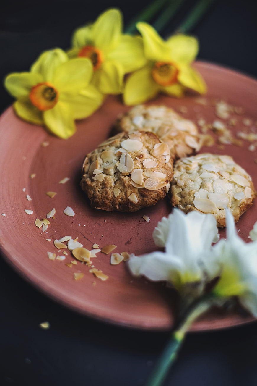 Almond cookies on terracotta plate with daffodils