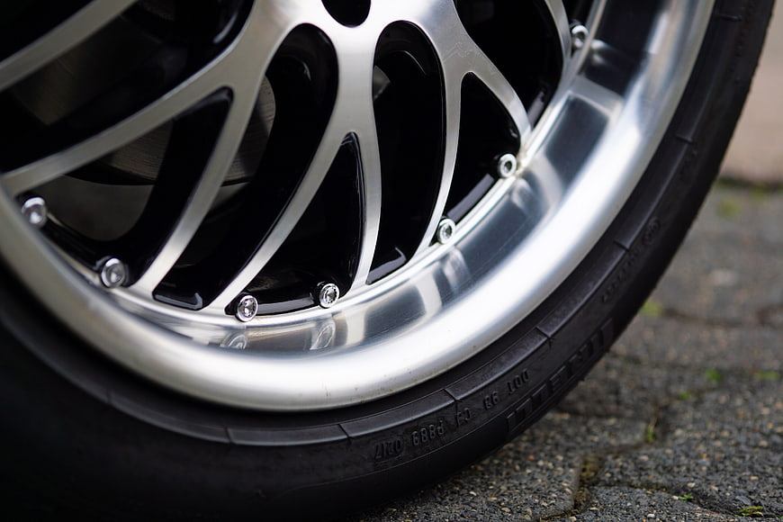 Stock Rim Color Close-up of a shiny silver alloy car wheel rim and tire | Pickpik