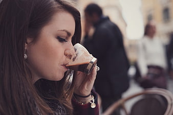 Woman Sipping Espresso at Outdoor Cafe