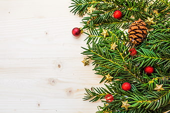 Christmas Pine Branches with Ornaments on White Wood